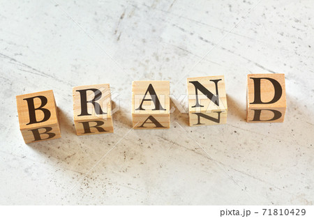 Five wooden cubes with word BRAND on white stone like board, view from above 71810429