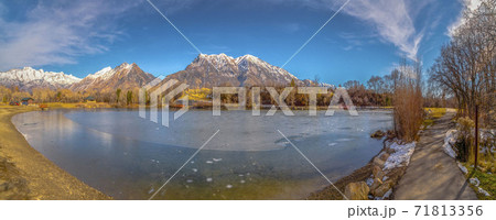 Clear Panorama Scenic panorama of a lake against snow capped mountain and blue sky in winter 71813356