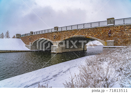 Oquirrh Lake with view of snowy trail and bridge 71813511