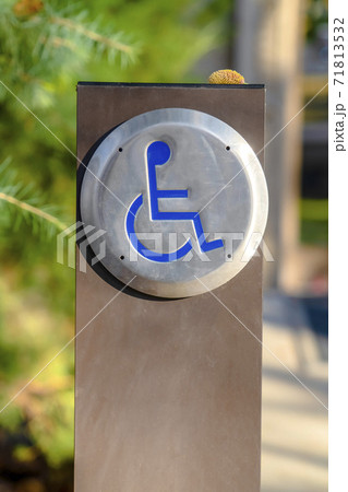 Close up of a Disabled Sign with a sunny landscape in the blurred background Close up of a Disabled Sign with a sunny landscape in the blurred background 71813532
