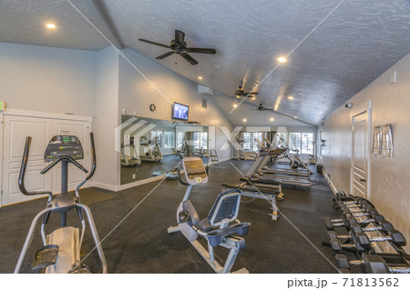 Interior of a spacious fitness gym with various exercise equipment 71813562