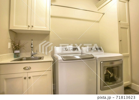 Washing machine and dryer inside the laundry room of a house Washing machine and dryer inside the laundry room of a house 71813623