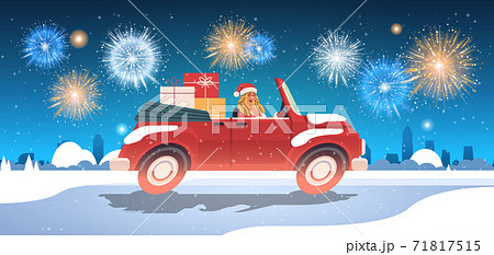 girl in santa claus costume delivering gifts on red car merry christmas happy new year holiday celebration 71817515