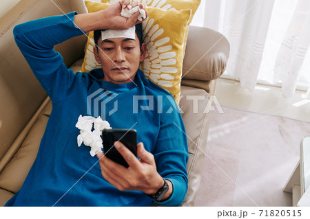 Sick man resting on sofa 71820515