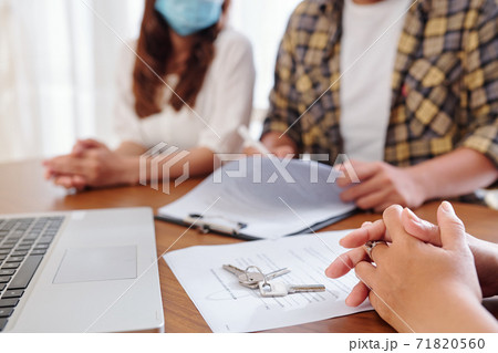 Couple meeting with real estate agent 71820560