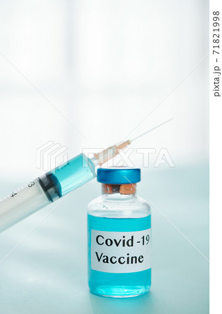 Covid-19 vaccine and syringe Covid-19 vaccine and syringe 71821998