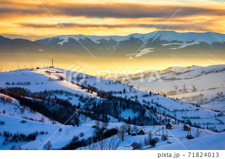 winter landscape in mountains at sunrise. beautiful rural area of carpathian mountains with snow covered hills. glowing clouds on the sky. frosty weather 71824013