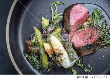 German asparagus potato salad with barbecue dry aged sliced fillet steak 71829071