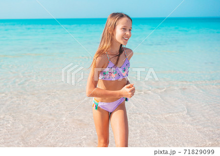 Adorable little girl at beach on her summer vacation Adorable little girl at beach on her summer vacation 71829099
