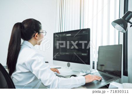 Asian woman professional development programming website working a software in office room. Asian woman professional development programming website working a software in office room. 71830311