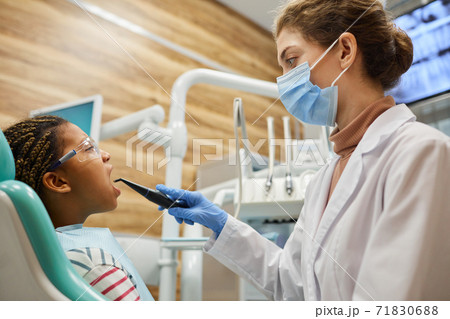 Dentist working with patient teeth Dentist working with patient teeth 71830688