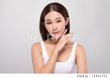 Beautiful Asian young woman touching soft cheek smile with clean and fresh skin Happiness and cheerful with positive emotional,isolated on gray background,Beauty and Cosmetics Concept 71831755