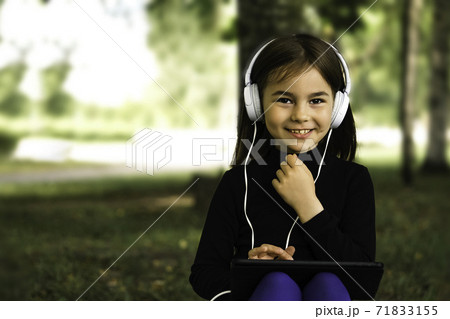 happy girl using digital tablet in the park 71833155