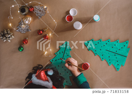 little kid making christmas decorations 71833158