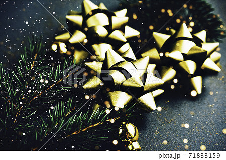 Christmas background. Golden bowknots on dark green background. Christmas background. Golden bowknots on dark green background. 71833159