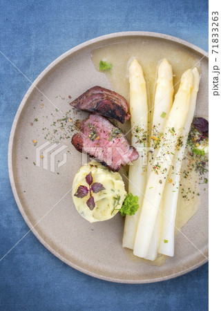 barbecue dry aged sliced fillet steak with white asparagus in butter sauce and mashed potatoes  71833263