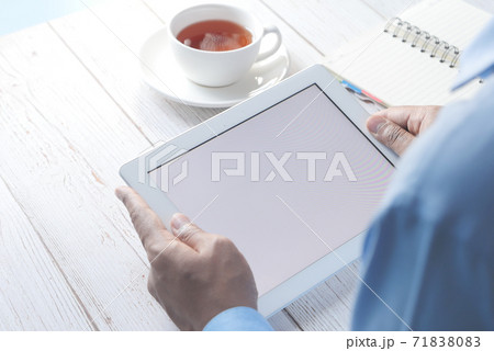 rear view of businessman using digital tablet on office desk  71838083