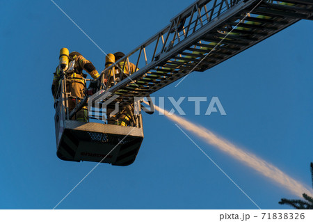 Firefighters extinguishing a blaze Firefighters extinguishing a blaze 71838326
