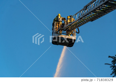 Firefighters extinguishing a blaze Firefighters extinguishing a blaze 71838329