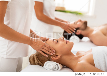 Couple Enjoying Head Massage Together Lying At Spa Center Indoors Couple Enjoying Head Massage Together Lying At Spa Center Indoors 71840643