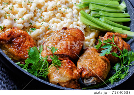roast chicken thighs with pasta in a skillet 71840683