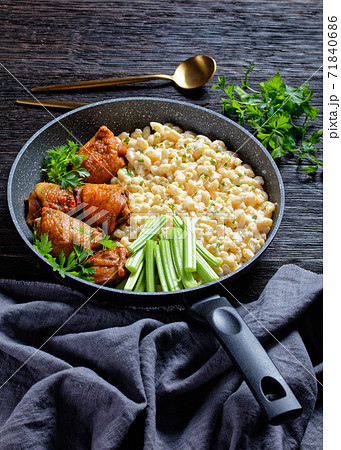 roast chicken thighs with pasta in a skillet 71840686