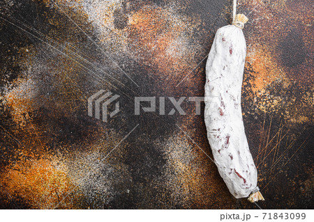 Salchichon sausage on dark background, flat lay with copy space Salchichon sausage on dark background, flat lay with copy space 71843099