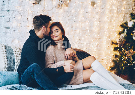 Happy caucasian couple in love having fun together near beautiful Christmas tree  71843882