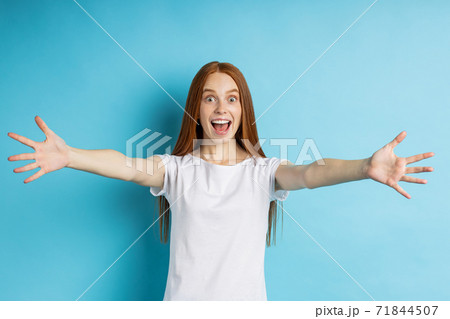 Portrait of young happy redhead woman in white t shirt 71844507