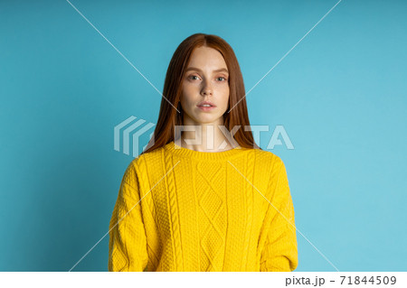 Studio shot of redhead caucasian young woman isolated blue background 71844509