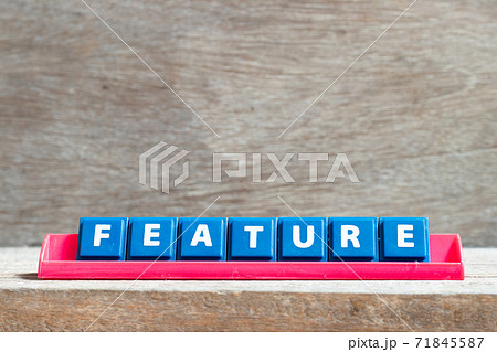 Tile letter on red rack in word feature on wood background 71845587