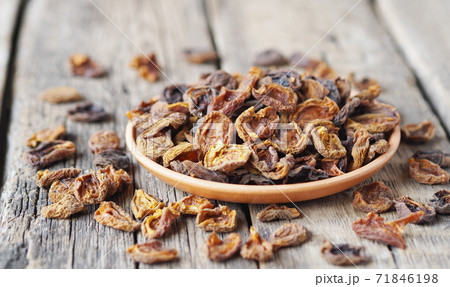 Wooden background with dried apricots.Home preparation of dried fruits. 71846198
