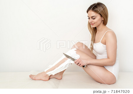 Woman shaves her legs. 71847020