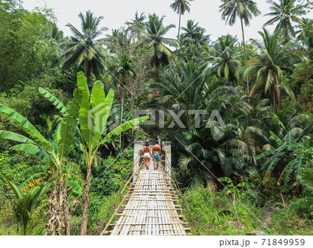 Lovely travel couple at the middle of the tropical jungle with palm trees and banana trees in Cebu Island, Philippines	 71849959