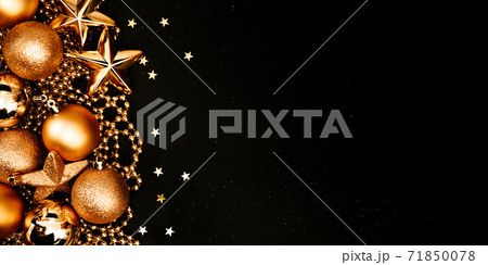 Christmas and New Year banner with copy space. Golden balls and stars on black backdrop. Christmas and New Year banner with copy space. Golden balls and stars on black backdrop. 71850078