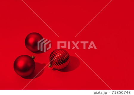 Christmas and New Year red balls with copy space on red backdrop. Hard light. Christmas and New Year red balls with copy space on red backdrop. Hard light. 71850748
