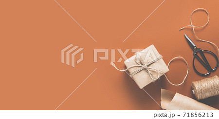 Gift box wrapped in craft paper with decor Gift box wrapped in craft paper with decor 71856213