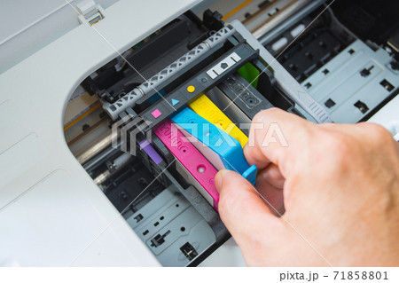 Technicians are install setup the ink cartridge of a inkjet printer the device of office automate for printing 71858801