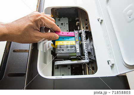 Technicians are install setup the ink cartridge of a inkjet printer the device of office automate for printing 71858803