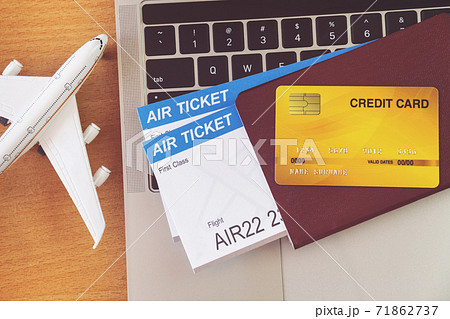 Air tickets and passports near laptop computer and airplane on table. Online ticket booking concept Air tickets and passports near laptop computer and airplane on table. Online ticket booking concept 71862737