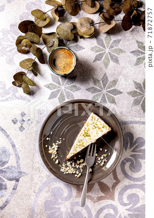 Raw vegan cheesecake with lime zest and cashew nuts on plate. Top view 71872757