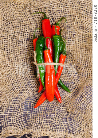 red and green hot chili pepper in a rustic style. Vintage style. 71873220