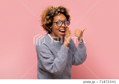Young african american woman with hand on mouth telling secret or rumor, whispering. Young african american woman with hand on mouth telling secret or rumor, whispering. 71873341