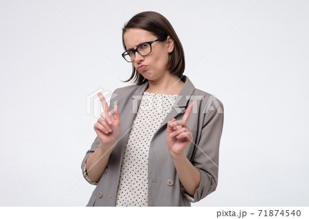 Mature woman gesturing a no sign raising finger up saying oh no you did not do that. Mature woman gesturing a no sign raising finger up saying oh no you did not do that. 71874540