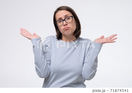 mature woman with clueless and confused expression with arms and hands raised mature woman with clueless and confused expression with arms and hands raised 71874541