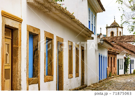 Old houses facades in colonial architecture and cobblestone streets Old houses facades in colonial architecture and cobblestone streets 71875063