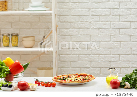 pizza and ingredients are placed on table pizza and ingredients are placed on table 71875440