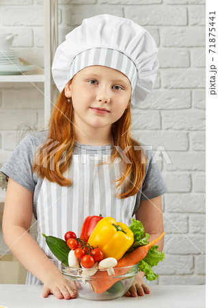 little child girl holding bowl of fresh vegetables little child girl holding bowl of fresh vegetables 71875441