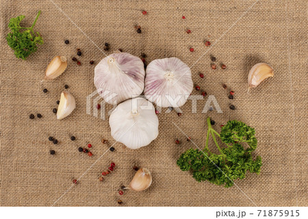 Garlic, Pepper and Parsley on Sacks background 71875915
