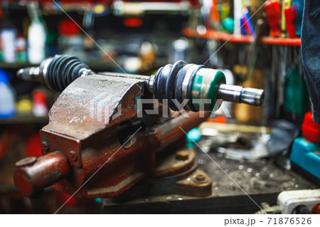 ATV constant-velocity CV joint repair in old garage ATV constant-velocity CV joint repair in old garage 71876526